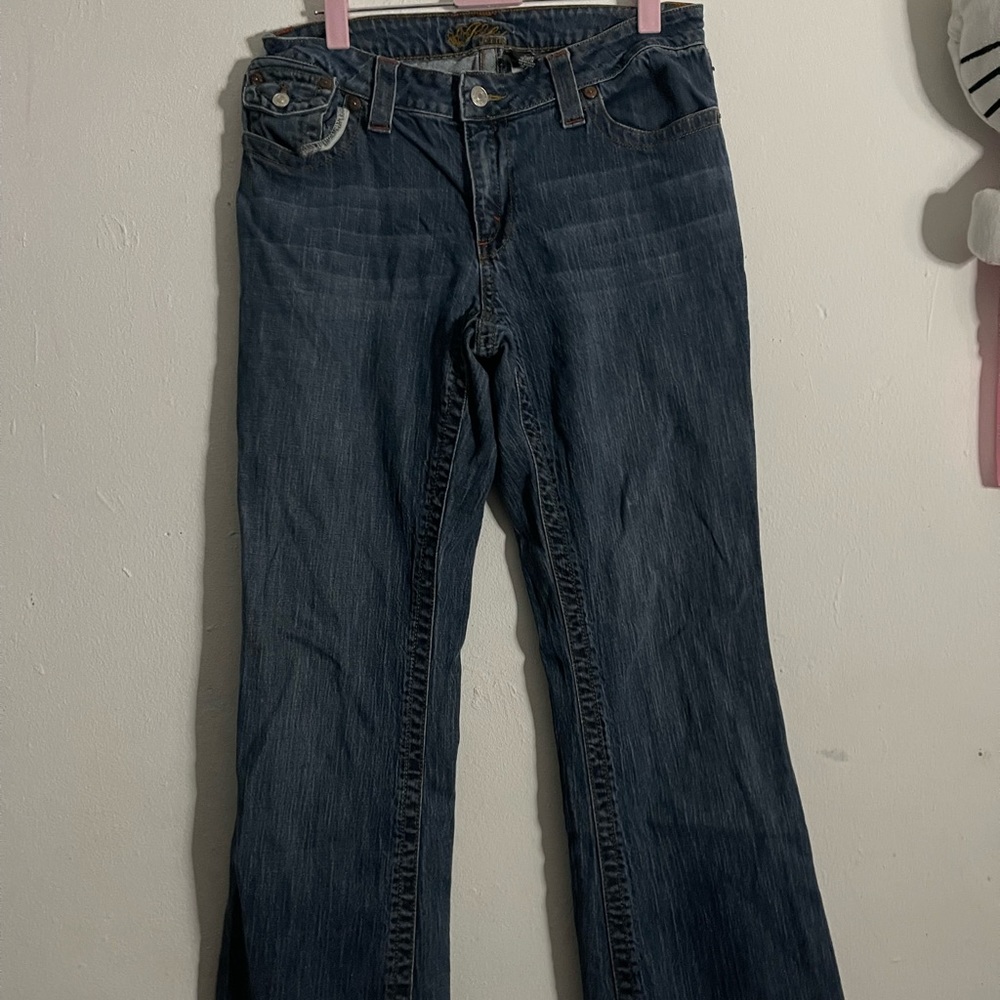 low rise boot jeans with red detailing on seams